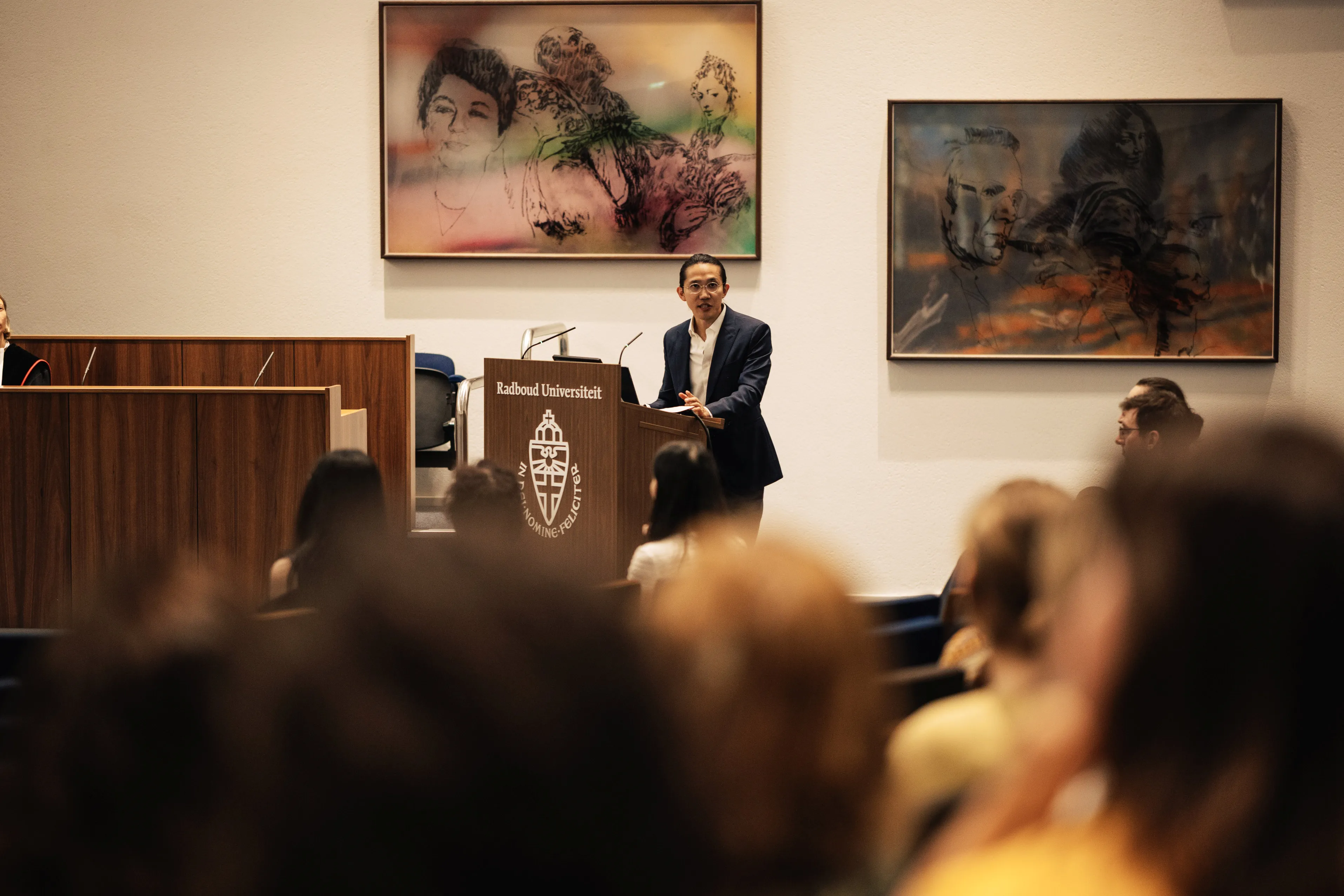 Edmund Lo speaking at the Radboud Universiteit lectern in the Aula during his PhD defence