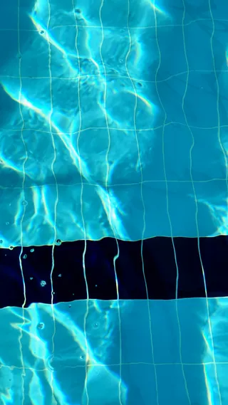 Blue swimming pool water with a lane divider